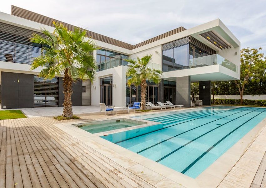 Explore this luxurious modern villa in Dubai with a stunning swimming pool and palm trees.
