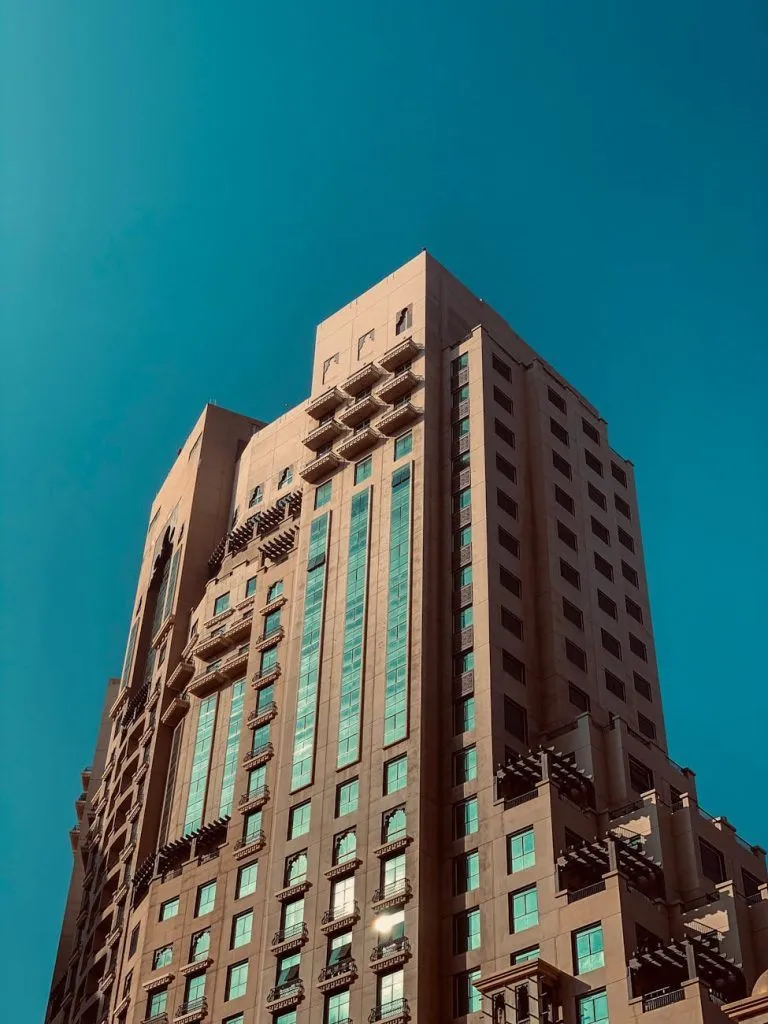 A striking modern residential building with clear blue sky in Dubai, UAE.